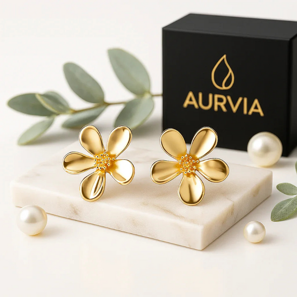 AURVIA Golden Bloom Anti-Tarnish Gold Floral Drop Earrings — intricate floral design with sparkling stones, displayed on marble surface. Luxury Indian jewelry for weddings, parties, daily wear.