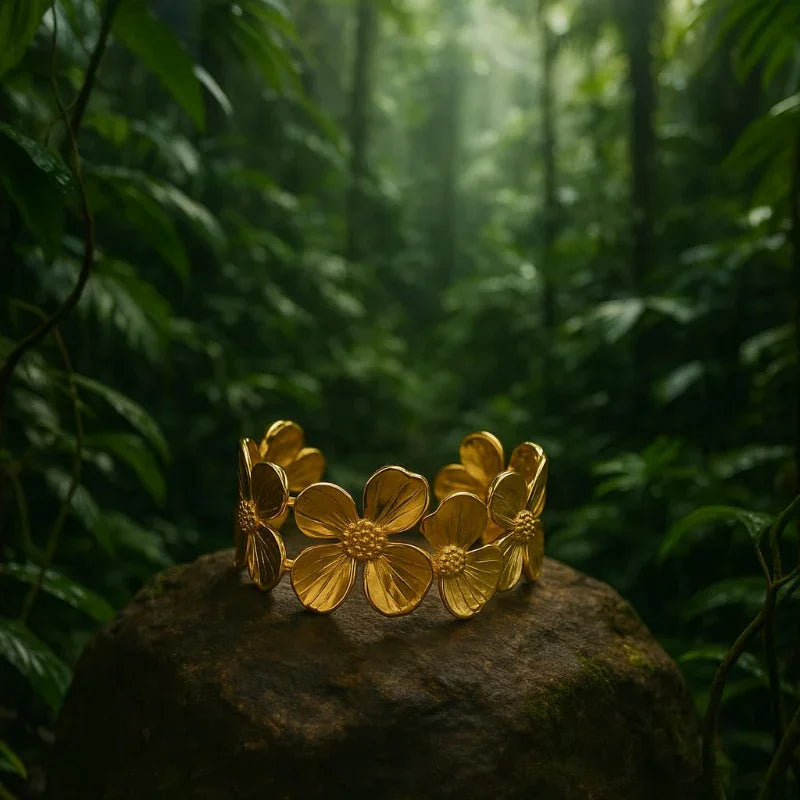 Gold floral bracelet on a rock with a forest background