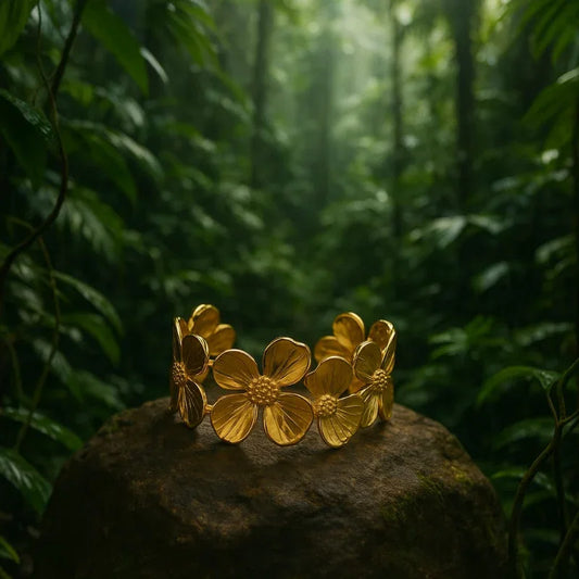 Gold floral bracelet on a rock with a forest background