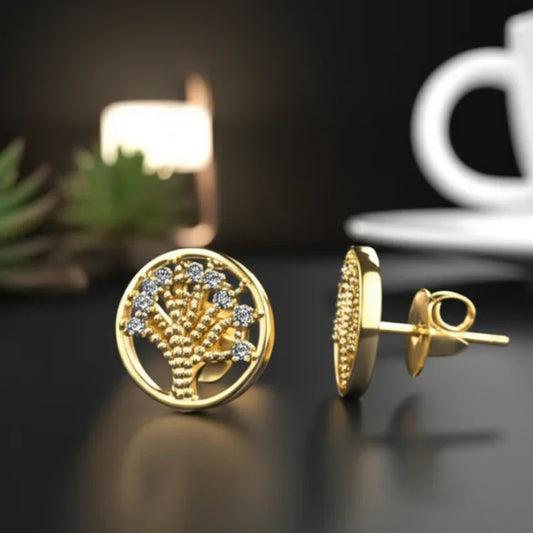 Gold earrings with intricate design on a dark surface with a blurred background