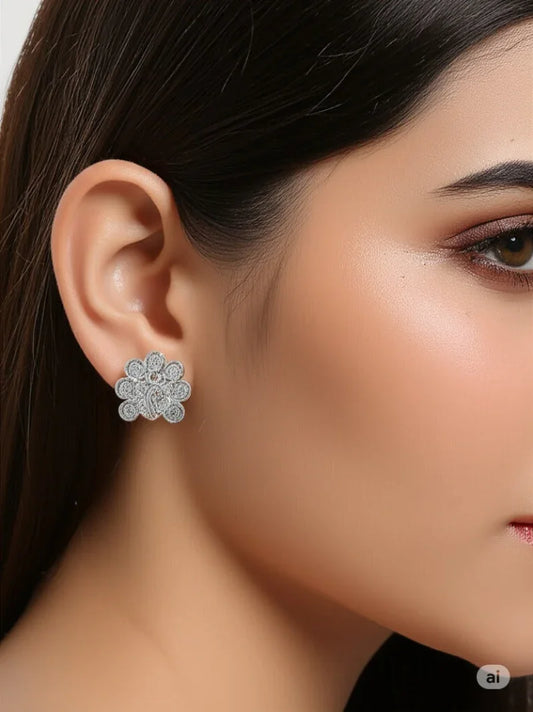 Close-up of a woman wearing a floral earring with a neutral background