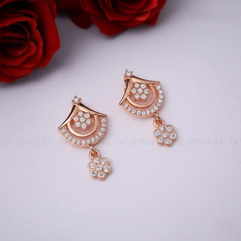 Rose gold earrings with crystal details on rose background - AURVIA

