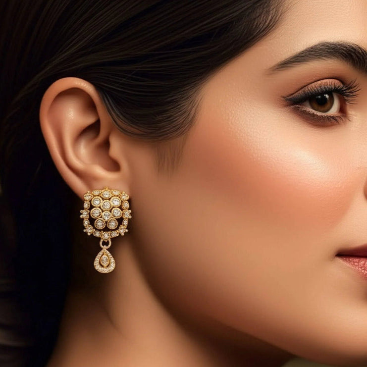 Close-up of a woman wearing a gold and diamond earring.