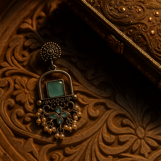 Decorative earring with turquoise stone on a wooden surface